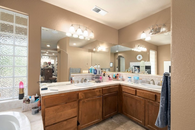 1710 N Filbert Ave, Clovis, CA 93619 - full bathroom featuring double vanity, tile patterned flooring, a textured wall, and a bathtub