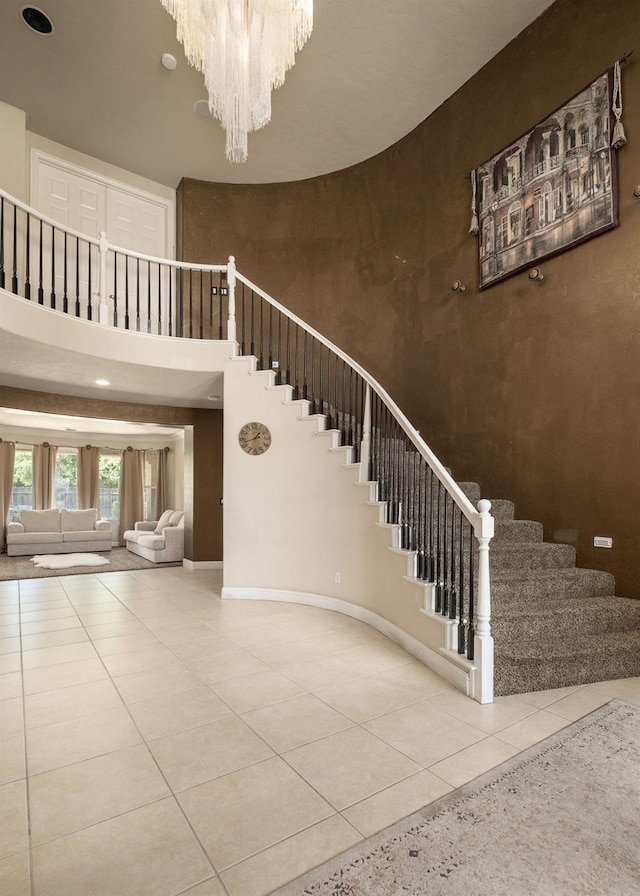 1710 N Filbert Ave, Clovis, CA 93619 - stairs featuring a towering ceiling, tile patterned floors, a chandelier, and baseboards