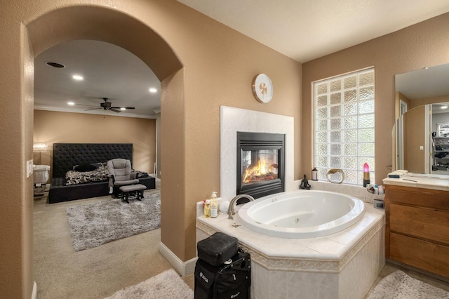 1710 N Filbert Ave, Clovis, CA 93619 - bathroom with ceiling fan, vanity, a jetted tub, and a tiled fireplace