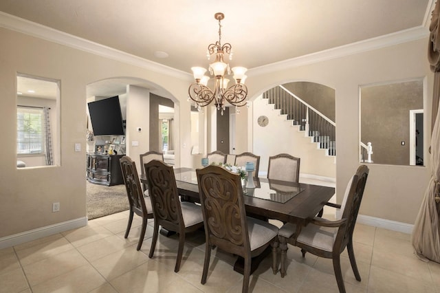1710 N Filbert Ave, Clovis, CA 93619 - dining room featuring a chandelier, ornamental molding, arched walkways, plenty of natural light, and baseboards