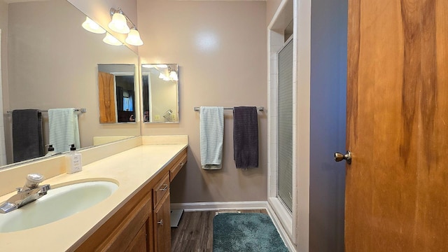 1205 Pine St, Selma, CA 93662 - bathroom featuring baseboards, a stall shower, wood finished floors, and vanity