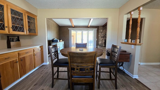 1205 Pine St, Selma, CA 93662 - dining area featuring dark wood-type flooring, a textured ceiling, and baseboards