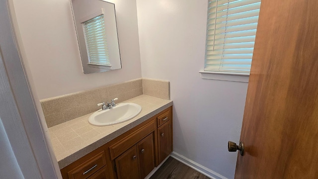 1205 Pine St, Selma, CA 93662 - bathroom with backsplash, vanity, and wood finished floors