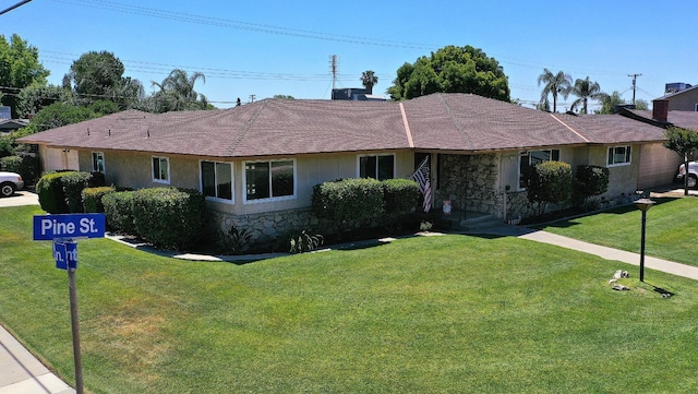 1205 Pine St, Selma, CA 93662 - single story home featuring a front yard, a shingled roof, and stone siding