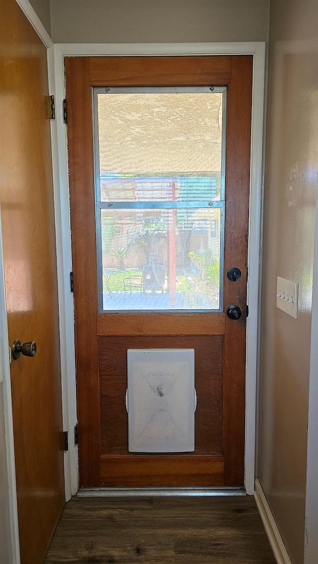 1205 Pine St, Selma, CA 93662 - doorway to outside featuring dark wood-style flooring and plenty of natural light