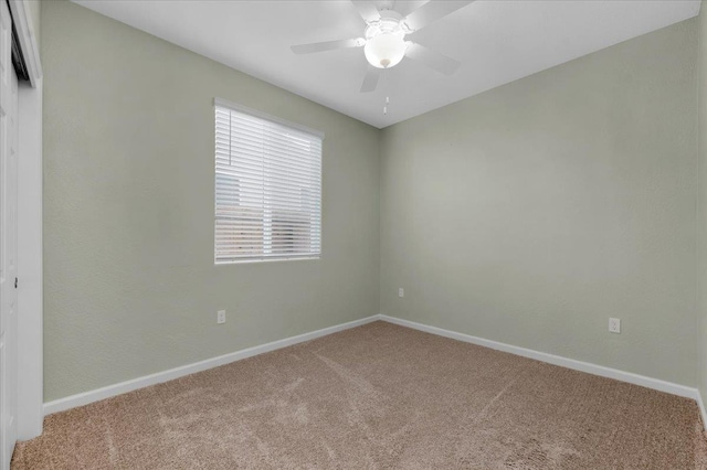 unfurnished room featuring carpet floors, baseboards, and a ceiling fan