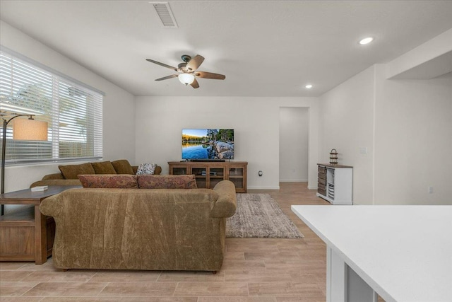 living room featuring a ceiling fan, light wood-style flooring, and recessed lighting