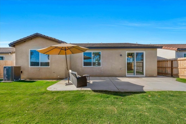 back of house with central AC unit, stucco siding, and a patio area