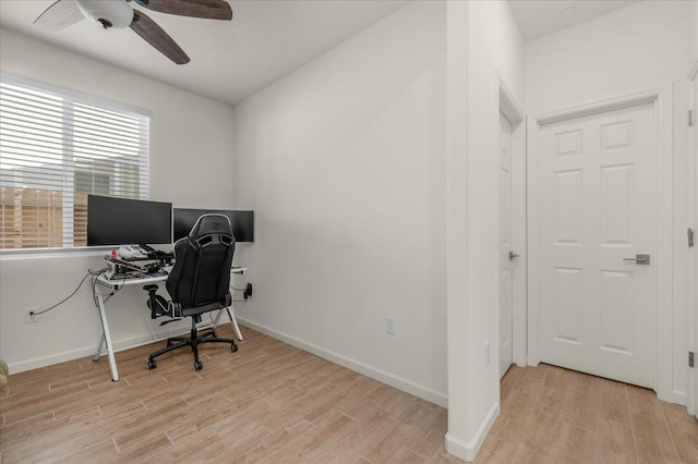 office space featuring ceiling fan, light wood-style floors, and baseboards