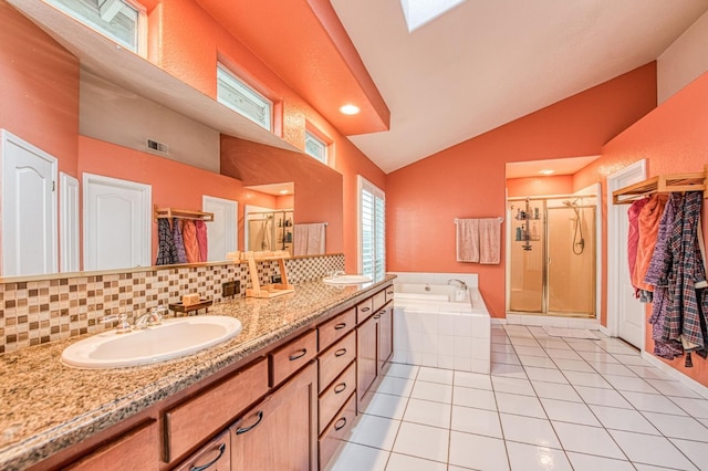 bathroom with a stall shower, a garden tub, double vanity, high vaulted ceiling, and tile patterned floors