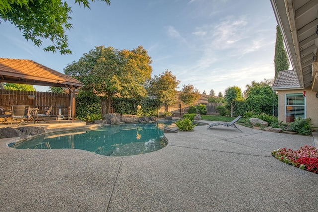 view of swimming pool featuring a patio, a fenced backyard, and a gazebo