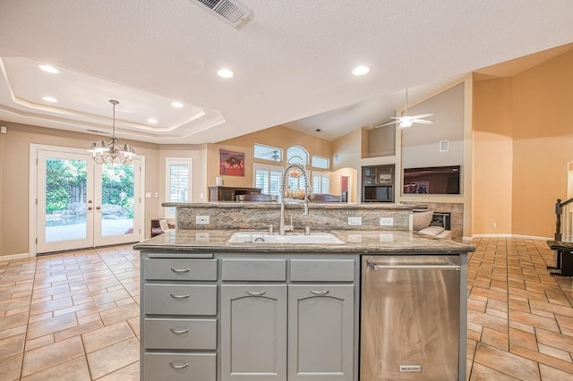 kitchen with a sink, gray cabinets, dishwasher, open floor plan, and recessed lighting