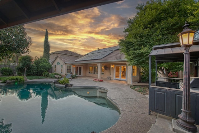 outdoor pool featuring french doors, a patio, and a gazebo