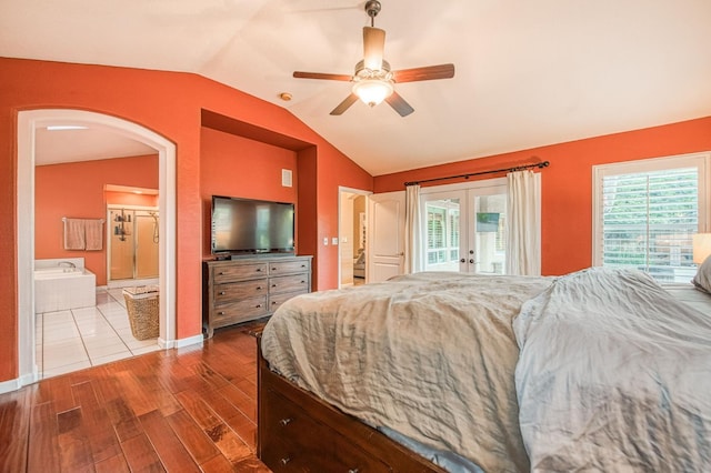 bedroom featuring lofted ceiling, access to exterior, french doors, arched walkways, and wood finished floors