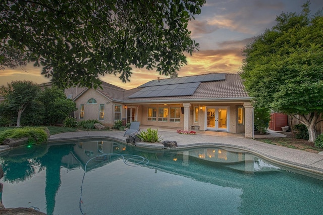 view of swimming pool with french doors, a patio, and fence