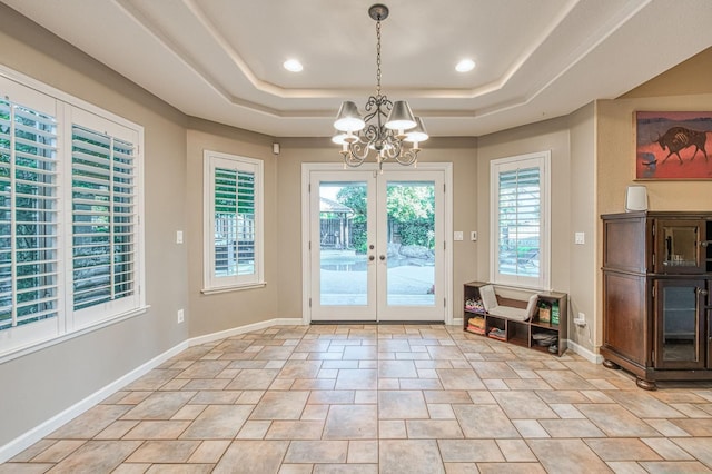 doorway featuring a chandelier, a tray ceiling, french doors, baseboards, and recessed lighting