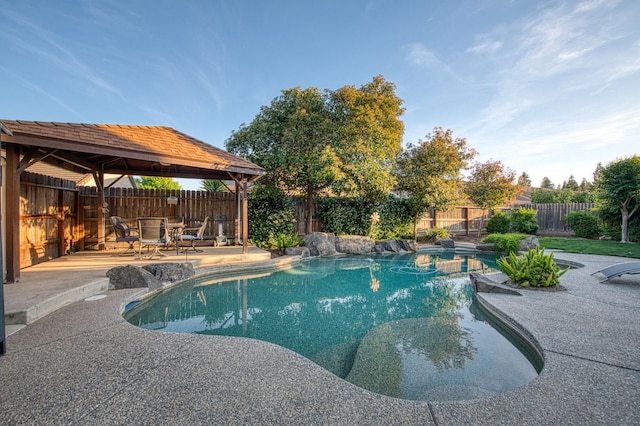 view of swimming pool featuring a gazebo, a patio area, and a fenced backyard