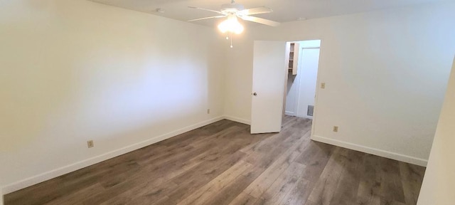 empty room featuring ceiling fan, wood finished floors, and baseboards