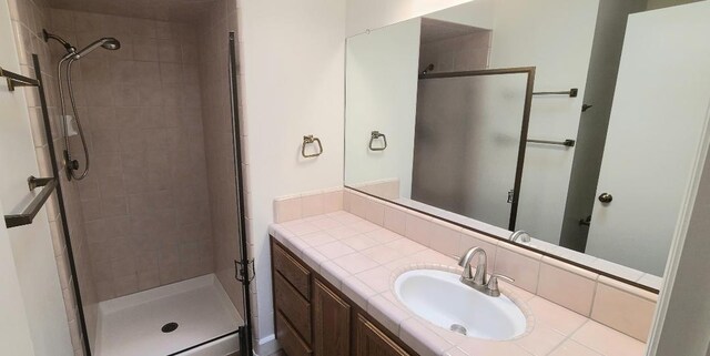 bathroom featuring a stall shower and vanity