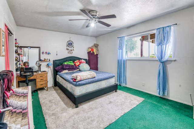 bedroom with carpet, a textured ceiling, a ceiling fan, and baseboards