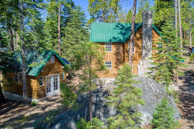 41533 Indian Rock Rd, Shaver Lake, CA 93664 - view of side of property with french doors, metal roof, and a chimney
