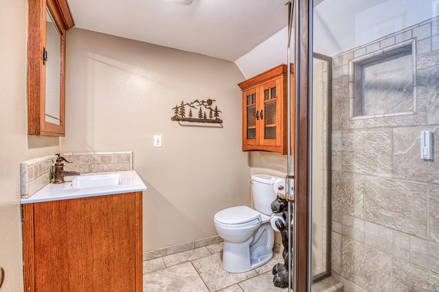 41533 Indian Rock Rd, Shaver Lake, CA 93664 - bathroom with toilet, vanity, a stall shower, baseboards, and tile patterned flooring