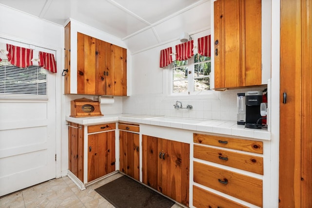 58374 Huntington Lake Rd Unit 12, Lakeshore, CA 93634 - kitchen with brown cabinetry, tasteful backsplash, a sink, and light countertops