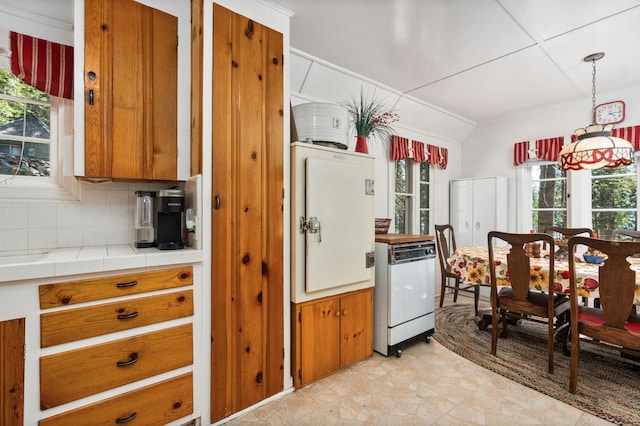 58374 Huntington Lake Rd Unit 12, Lakeshore, CA 93634 - kitchen featuring white dishwasher, brown cabinets, decorative backsplash, tile counters, and pendant lighting