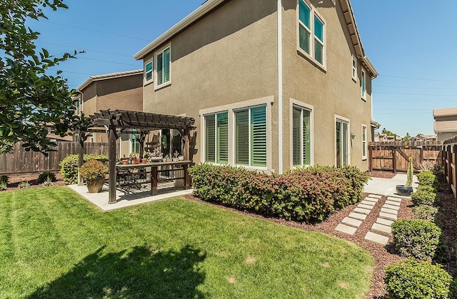 7005 N Astoria Ave, Fresno, CA 93722 - rear view of house with a pergola, a patio, and stucco siding