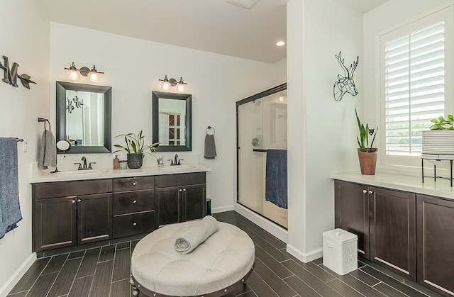 7005 N Astoria Ave, Fresno, CA 93722 - full bath featuring baseboards, wood tiled floors, a stall shower, double vanity, and recessed lighting