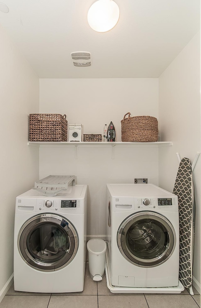 7005 N Astoria Ave, Fresno, CA 93722 - clothes washing area featuring washing machine and clothes dryer and light tile patterned flooring