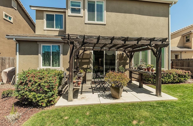 7005 N Astoria Ave, Fresno, CA 93722 - back of house featuring a pergola, stucco siding, and a patio