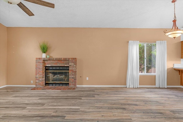 6380 N Cleo, Fresno, CA 93722 - unfurnished living room featuring ceiling fan, wood finished floors, and a fireplace