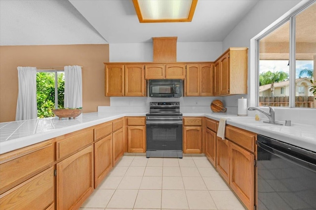 6380 N Cleo, Fresno, CA 93722 - kitchen with black appliances, a sink, light tile patterned floors, and tile countertops