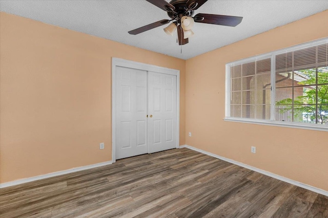 6380 N Cleo, Fresno, CA 93722 - unfurnished bedroom featuring wood finished floors, baseboards, a closet, ceiling fan, and a textured ceiling