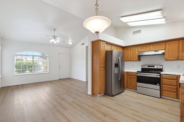 7307 N Lola Ave, Fresno, CA 93722 - kitchen with stainless steel appliances, under cabinet range hood, lofted ceiling, ceiling fan, and tasteful backsplash