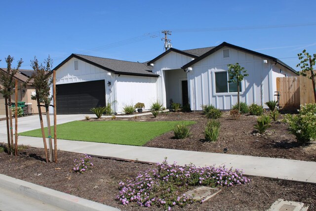 2158 W Ambassador Way, Hanford, CA 93230 - modern inspired farmhouse featuring an attached garage, concrete driveway, and board and batten siding
