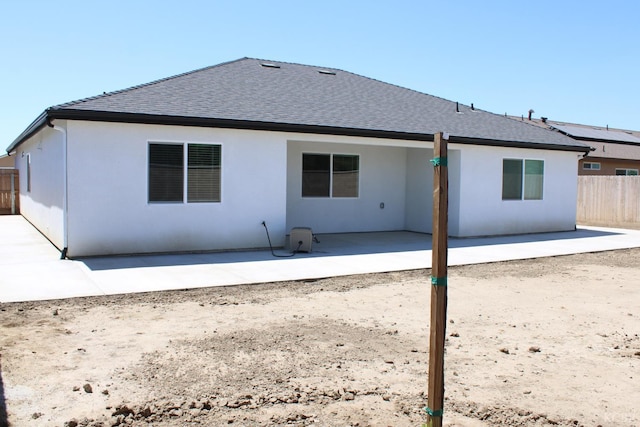 2158 W Ambassador Way, Hanford, CA 93230 - back of house featuring a shingled roof, a patio, fence, and stucco siding