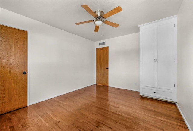 3512 E Simpson Ave, Fresno, CA 93703 - unfurnished bedroom featuring wood finished floors, baseboards, and ceiling fan