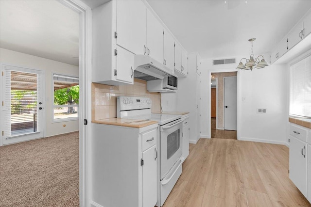 3512 E Simpson Ave, Fresno, CA 93703 - kitchen featuring electric range, a chandelier, light countertops, white cabinetry, and plenty of natural light