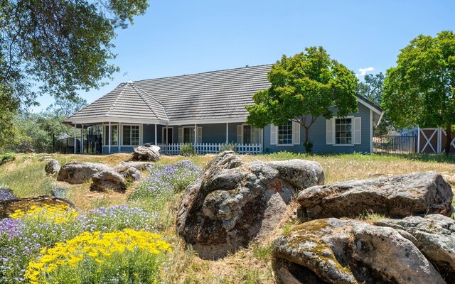 43480 Cave Stone Ct, Coarsegold, CA 93614 - rear view of house featuring fence and a porch