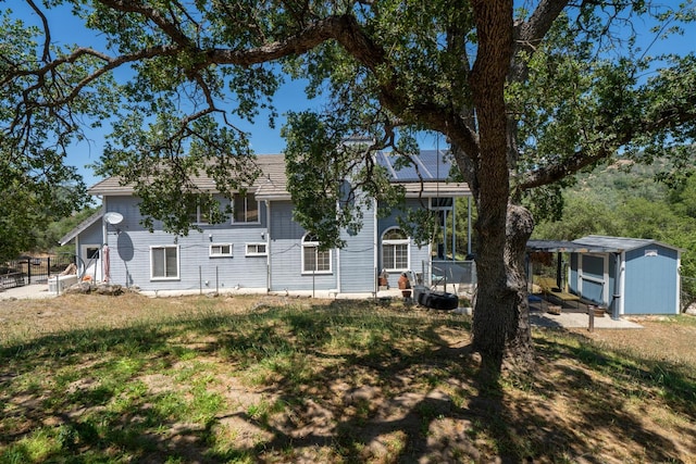 43480 Cave Stone Ct, Coarsegold, CA 93614 - rear view of property with a shed and an outbuilding