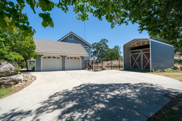 43480 Cave Stone Ct, Coarsegold, CA 93614 - view of property exterior featuring fence, an outdoor structure, a garage, and concrete driveway