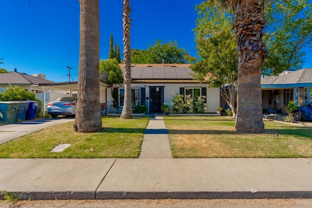1428 E Simpson, Fresno, CA 93704 - ranch-style house with roof mounted solar panels, a front yard, and stucco siding