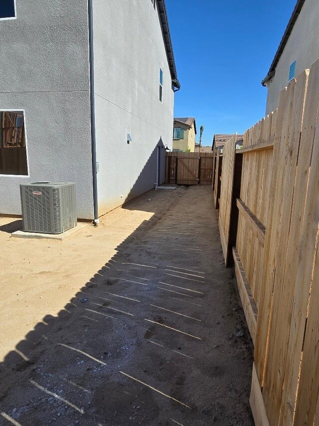 2875 E Colina Dr, Fresno, CA 93730 - view of property exterior with central AC unit and stucco siding