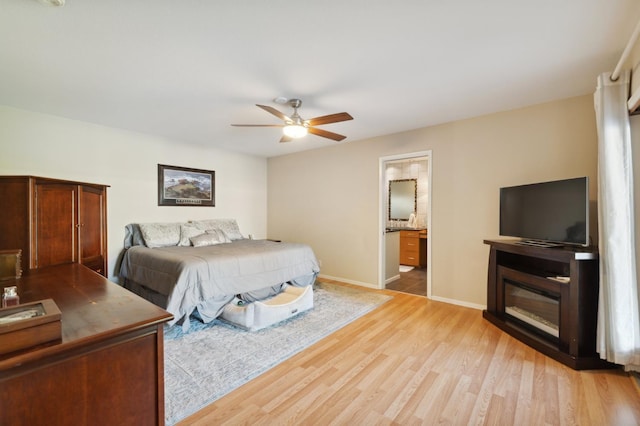 1478 W Dovewood Ln, Fresno, CA 93711 - bedroom with light wood-style flooring, baseboards, a ceiling fan, and ensuite bath