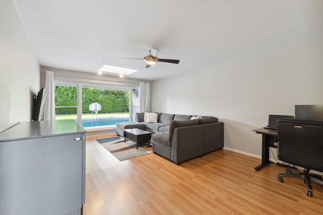 1478 W Dovewood Ln, Fresno, CA 93711 - living area featuring a ceiling fan, light wood finished floors, a skylight, and baseboards
