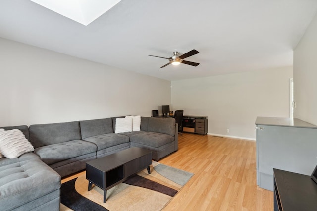 1478 W Dovewood Ln, Fresno, CA 93711 - living room with light wood-type flooring, ceiling fan, an office area, and baseboards