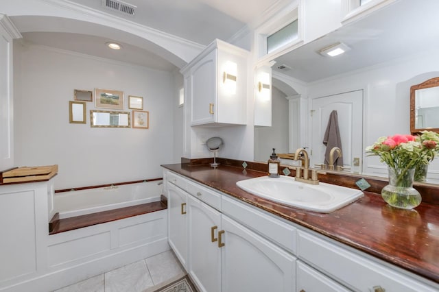 3519 N Van Ness Blvd, Fresno, CA 93704 - bathroom with vanity, crown molding, a garden tub, and tile patterned flooring
