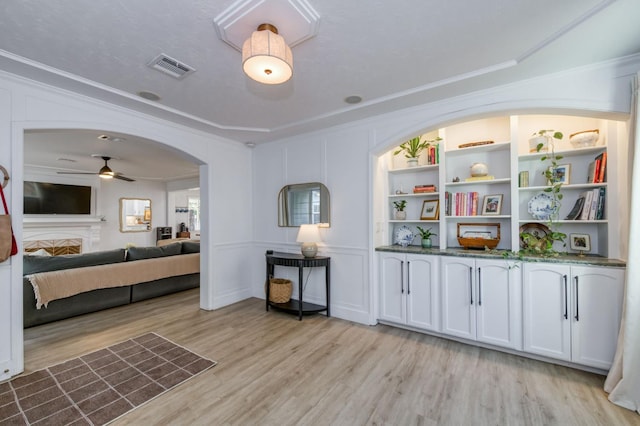 3519 N Van Ness Blvd, Fresno, CA 93704 - sitting room featuring light wood-style floors, a ceiling fan, ornamental molding, and arched walkways